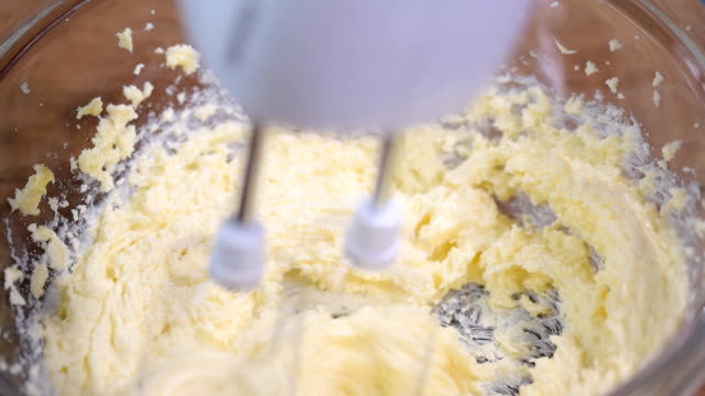 Adding-eggs-to-dough.-Making-cake-in-the-kitchen.