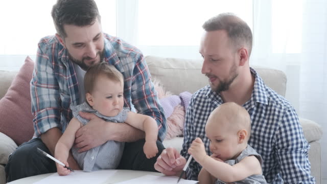 Zwei-Väter-mit-Baby-Mädchen-ziehen-auf-Papier