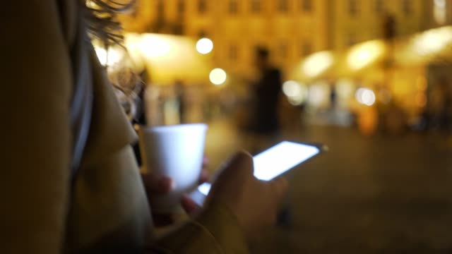 Girl-using-smartphone-on-city-street