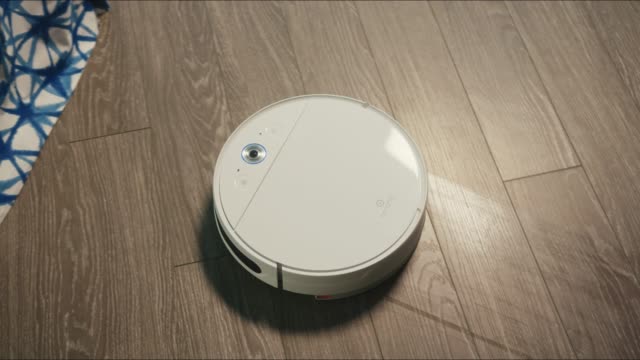 Close-up-of-the-robotic-vacuum-cleaner-riding-around-and-cleaning-up-apartments