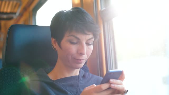 woman-uses-a-smartphone-in-a-train