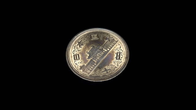 Japanische-Münze-Yen-rotiert-auf-schwarzem-Hintergrund.-Makro.-Closeup