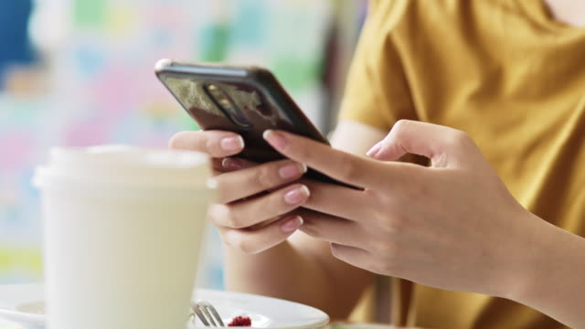 Handheld-view-of-woman-enjoying-the-free-internet-at-cafe