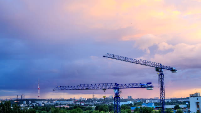 Work-of-construction-cranes-at-sunset