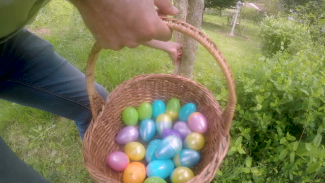 Man-hiding-an-Easter-egg-for-a-traditional-Easter-egg-hunt