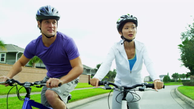 Asian-Chinese-male-female-couple-cycling-outdoors-together