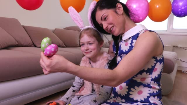 Mother-showing-for-daughter-decorative-Easter-eggs