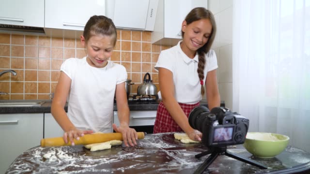 Young-vloggers-recording-video-content-for-food-blog-rolling-dough-with-rolling-pin