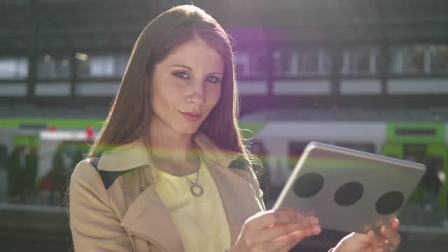 Young-attractive-Caucasian-woman-using-tablet-computer-at-train-station