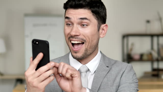 Businessman-Excited-for-Success-on-Smartphone