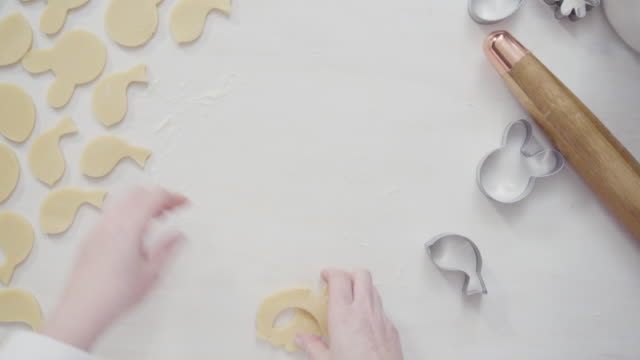 Cutting-sugar-cookie-dough-with-Easter-shaped-cookie-cutters.
