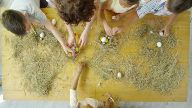 Top-View-of-Children-and-Teacher-Preparing-Easter-Decorations-in-Art-Class