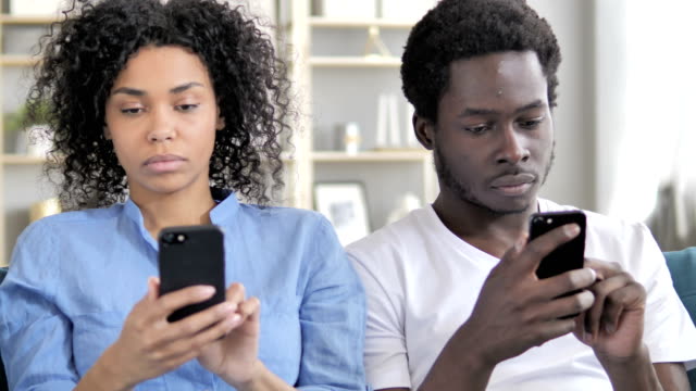 African-Man-and-Woman-Using-Smartphone
