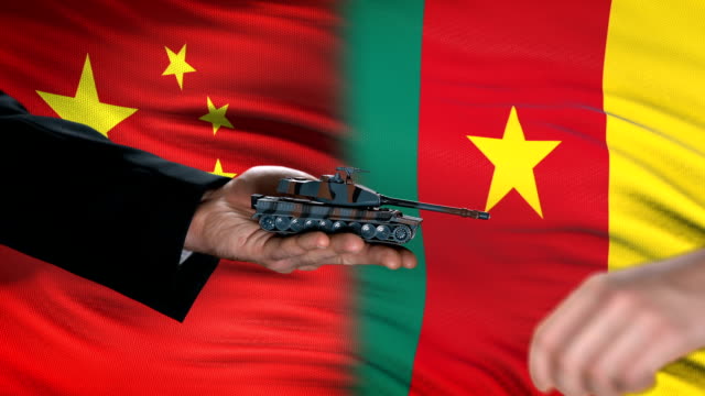 China-and-Cameroon-officials-exchanging-tank-money,-arms-trade,-flag-background