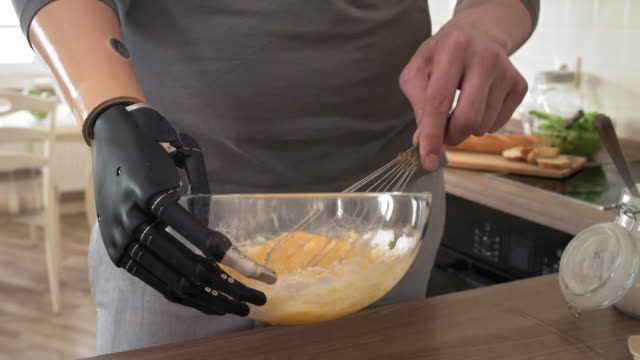 Male-Amputee-with-Bionic-Wrist-Holding-Bowl-and-Mixing-Batter