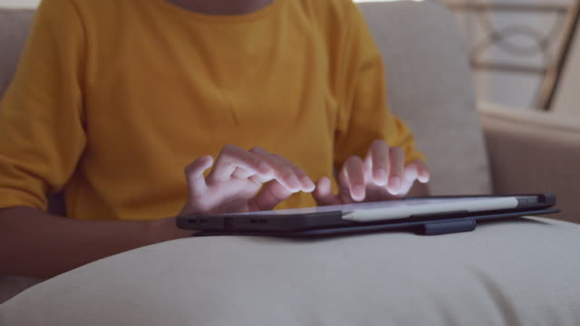 Hand-touching-keyboard-on-modern-digital-tablet