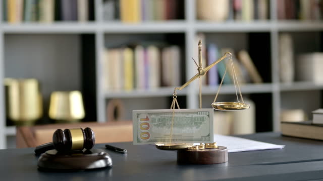 Close-up-Shoot-of-Scale-holding-Money-with-Gravel-on-Court-Desk