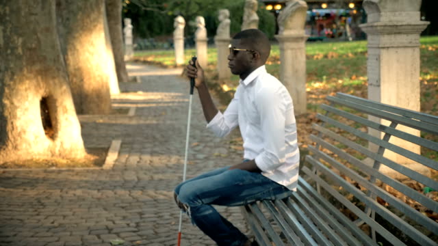 blindness,-independence.Blind-African-man-sitting-on-bench-in-the-park