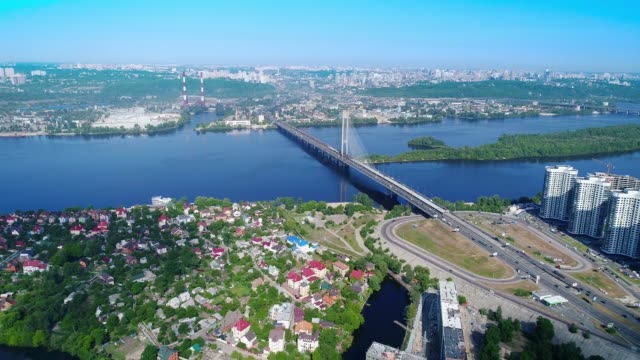 Aerial-drone-of-the-south-bridge,-the-city-of-Kiev.-Ukraine.-Dnieper-river,-the-bridge-crosses-the-river.-Cityscape-aerial-view-bridge-on-the-river-two-guys-climb-to-the-top-of-the-bridge