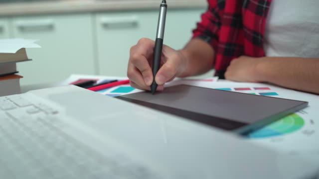 Freelance-designer-drawing-image-on-computer-pad,-hands-close-up,-modern-job