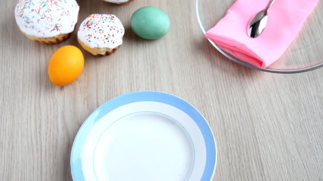 On-the-festive-table-alongside-with-painted-eggs-appears-dish-and-Easter-cake.