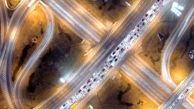 Hyperlapse-timelapse-of-night-city-traffic.-vertical-aerial-view.