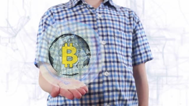 Young-man-shows-a-hologram-of-the-planet-Earth-and-Sign-BTC