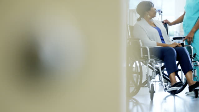 African-American-female-doctor-and-patient-in-wheelchair