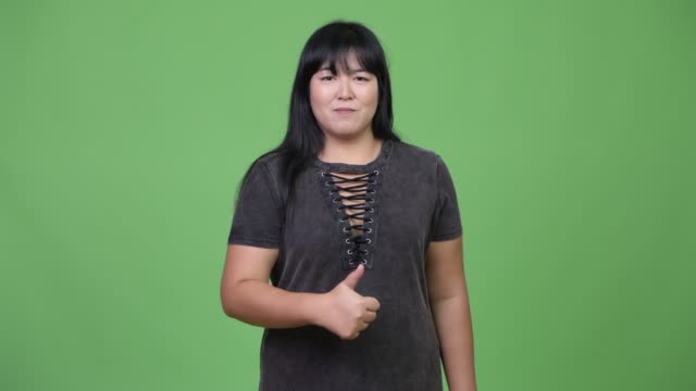 Beautiful-overweight-Asian-woman-giving-thumbs-up
