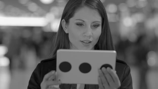 Good-looking-Caucasian-lady-texting-messages-and-sending-data-on-digital-tablet