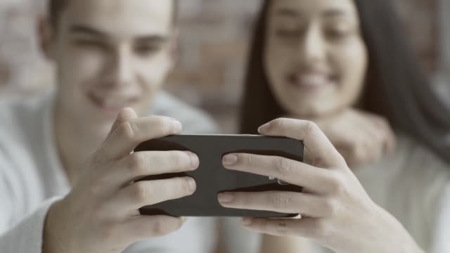 Friends-watching-a-video-together-on-a-smartphone