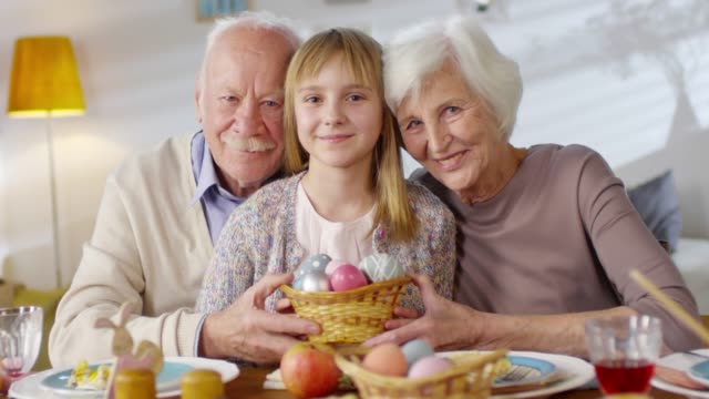 Portrait-of-Grandparents-and-Granddaughter-Celebrating-Easter
