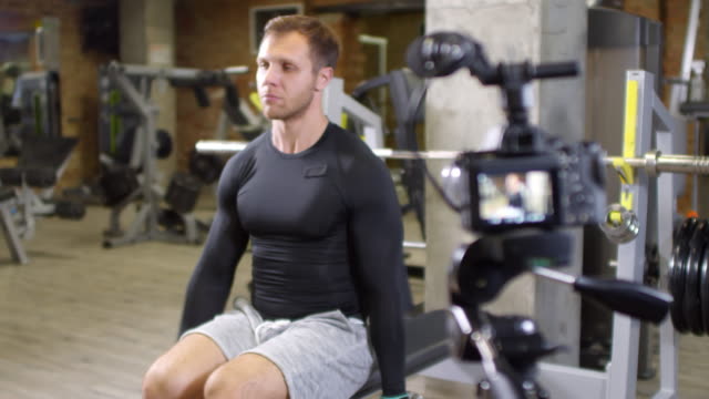 Athletic-Man-Exercising-with-Dumbbells-on-Camera