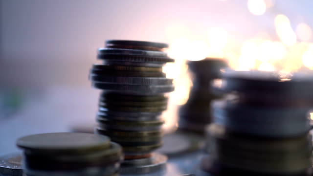 Double-exposure-of-city-view-and-rows-of-coins-for-finance-,-money-,-investment-and-business-concept-background