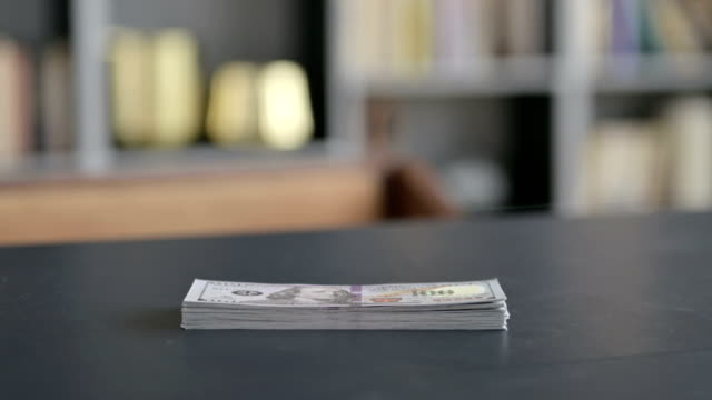 Close-Up-of-Money-on-Businessman-Office-Table
