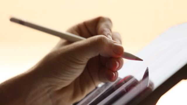 Graphic-designer-using-digital-stylus-pen-on-digital-tablet