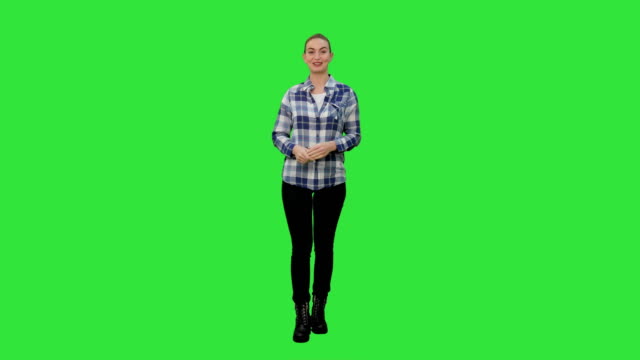 Happy-smiling-woman-in-casual-presenting-and-showing-something-on-a-Green-Screen,-Chroma-Key
