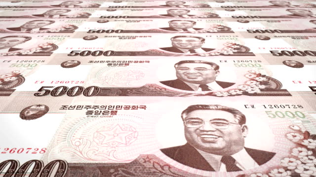 Billetes-de-cinco-mil-wons-de-Corea-del-Norte-rodando,-dinero-en-efectivo,-bucle