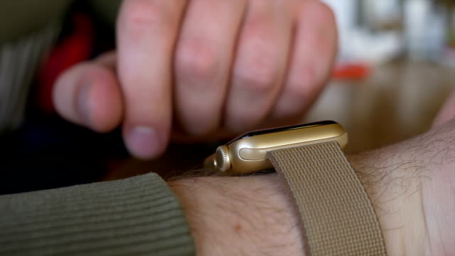 Closeup-of-man-hand-checking-time-and-working-with-smartwatch