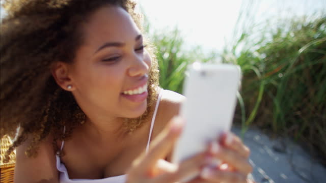 Plus-size-Ethnic-female-taking-smart-phone-selfie