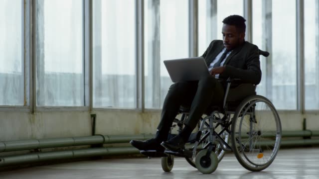 Businessman-in-Wheelchair-Working-on-Laptop