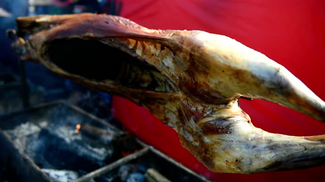 Whole-lamp-roasting-on-a-spit-over-charcoal-barbecue