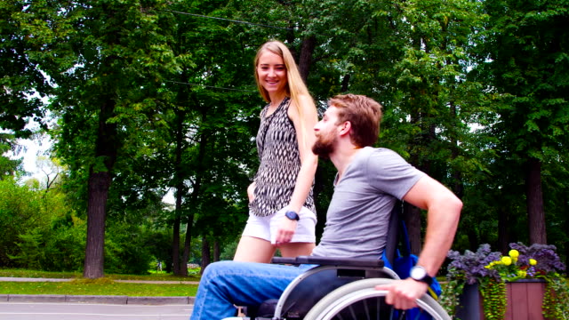 Young-disable-man-walking-in-the-park-with-his-wife