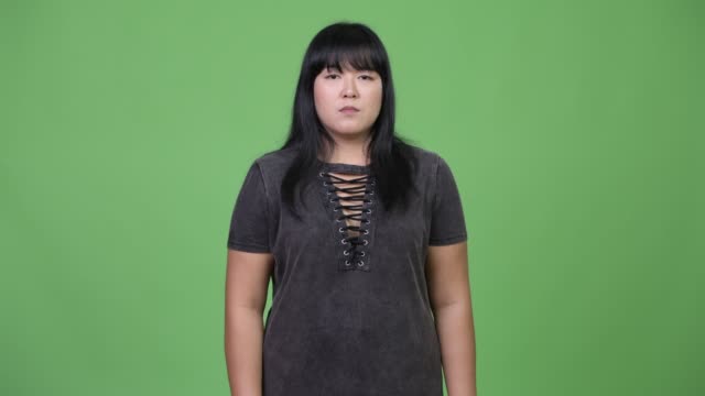 Beautiful-overweight-Asian-woman-covering-ears-as-three-wise-monkeys-concept