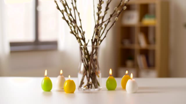 willow-and-candles-in-shape-of-easter-eggs-at-home