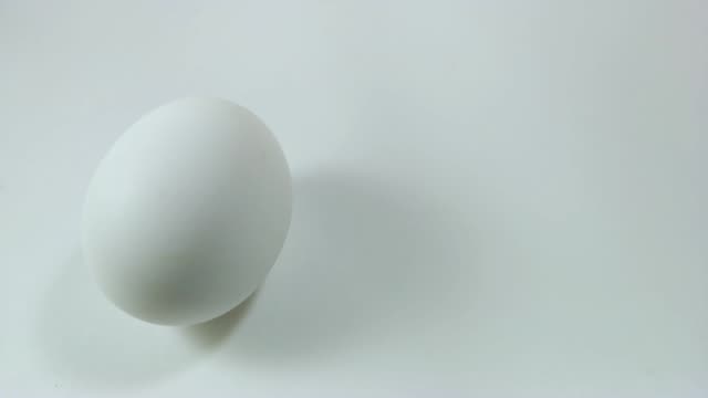 Egg-spinning-and-rolling-on-the-white-table-Easter-egg