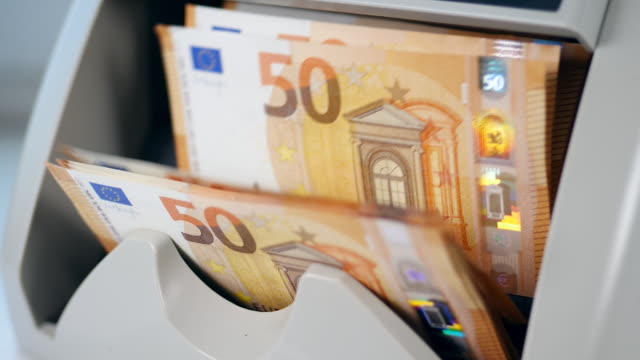 Banknotes-checker-counts-orange-euros.
