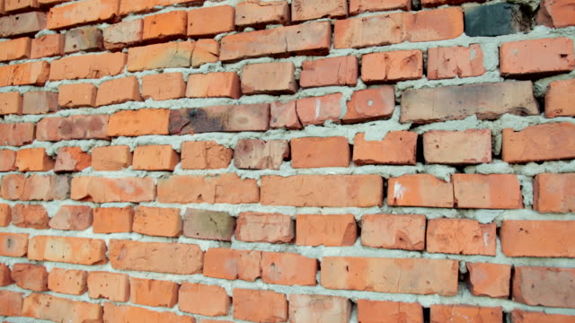 red-brick-and-stone-wall-with-damaged-old-brick,-background-for-design