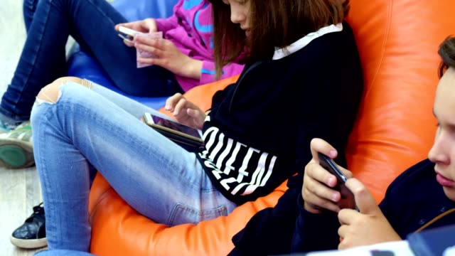 teenagers-children-use-gadgets,-smartphones,-chat-in-social-networks.-the-concept-of-children's-addiction-of-phones-and-tablets