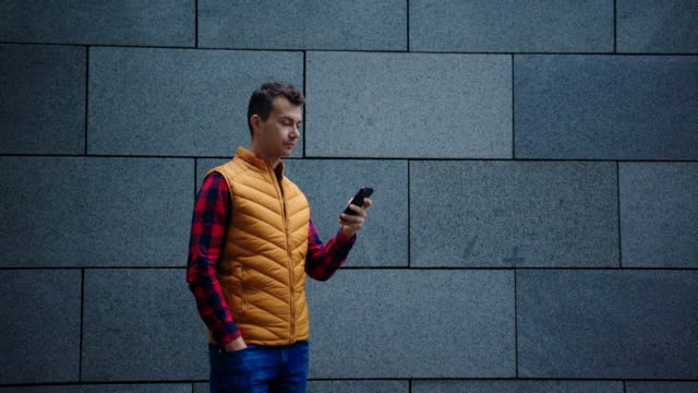 Man-hipster-millennial-looks-social-media-feed-on-smartphone